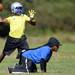 A Lincoln football player looks to pass the ball as a coach looks on during practice at the school on Wednesday, August 14, 2013. Melanie Maxwell | AnnArbor.com